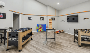 A room with a pool table and air conditioner.